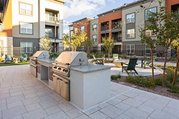 A modern outdoor kitchen with bbqs